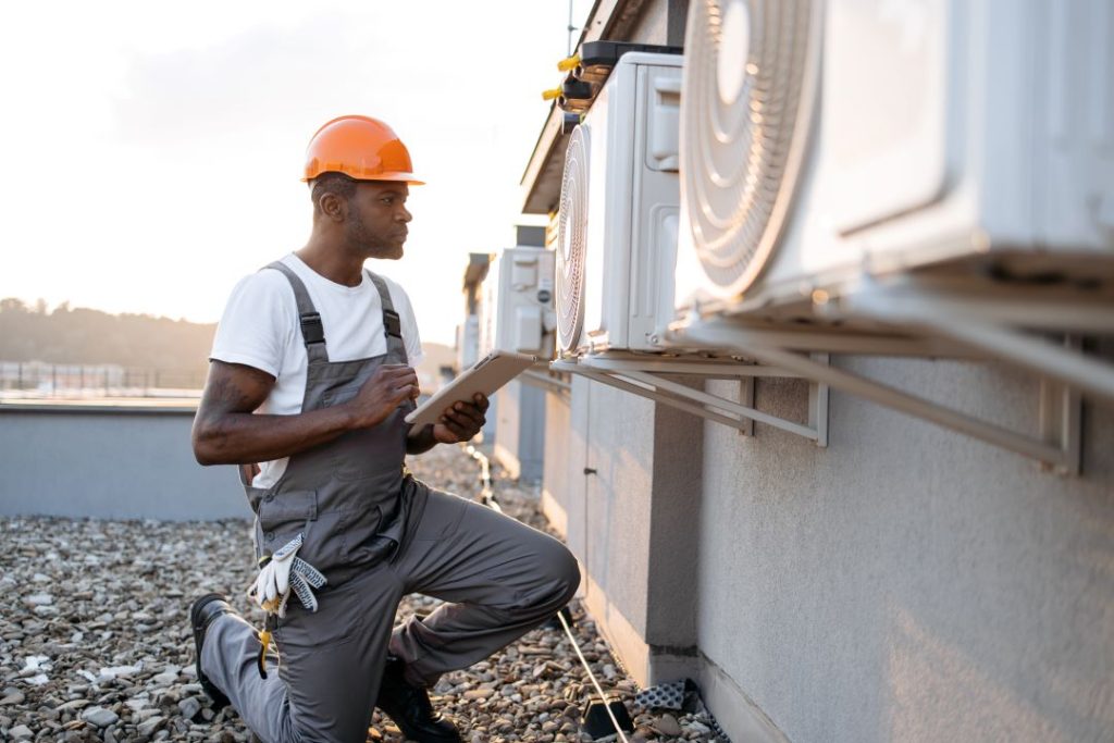 HVAC technician inspecting a system to ensure proper functioning